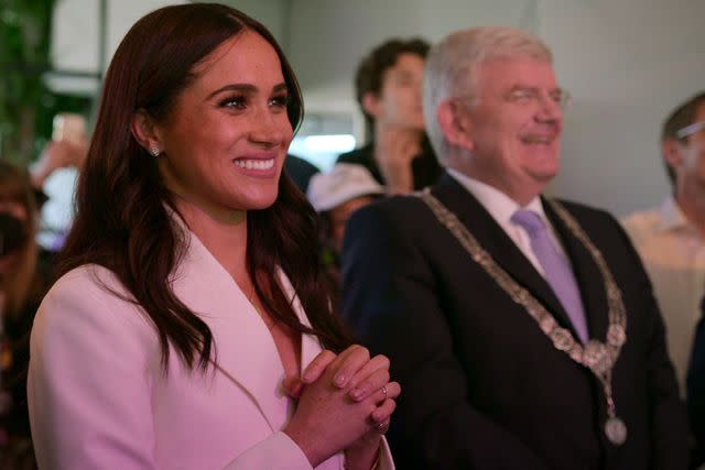 <p>Courtesy of Netflix</p> Meghan Markle smiles at Invictus Games in The Haguein 2022, as seen in "Heart of Invictus"; on Netflix.