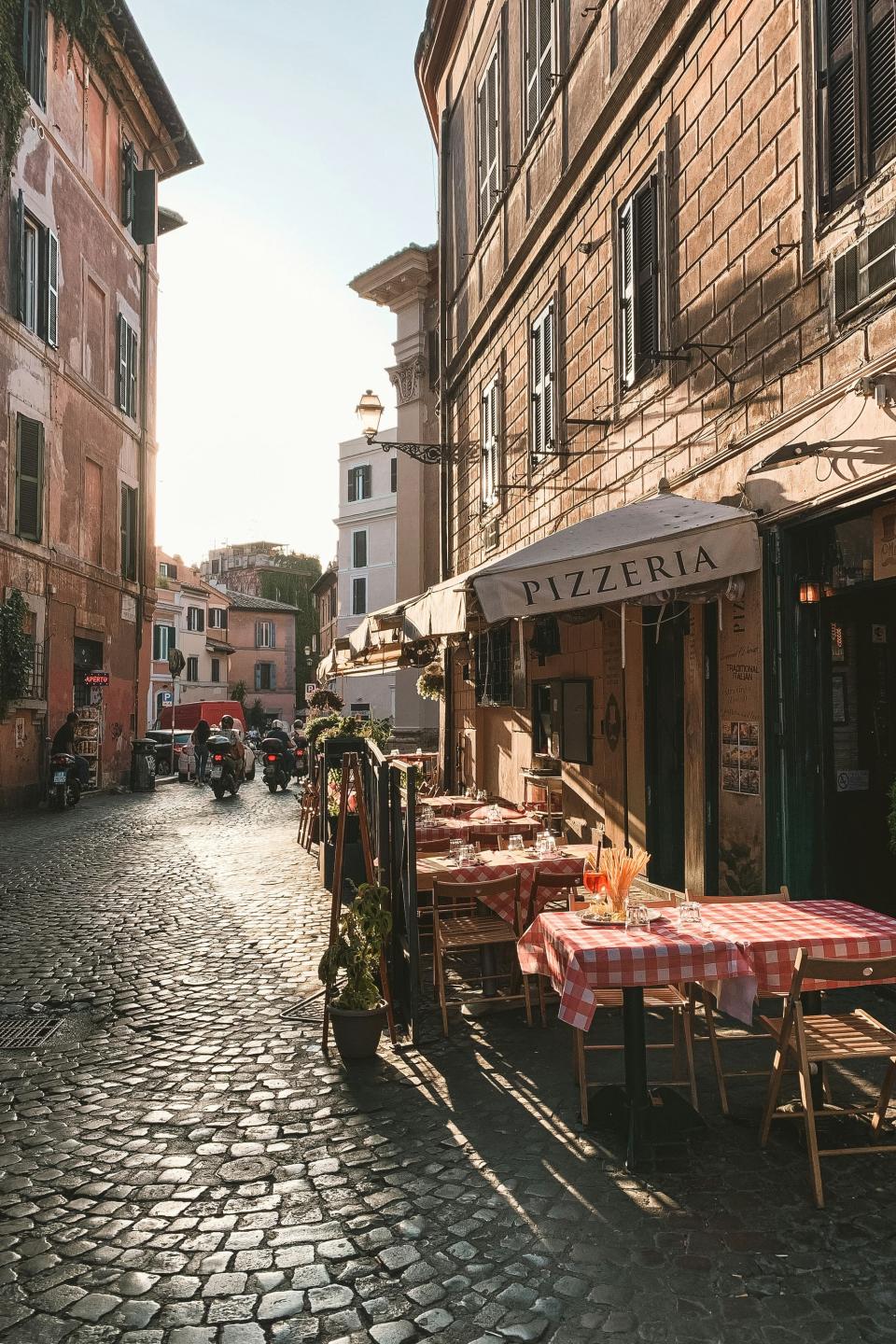 Café tables line the streets of Trastevere, known for its traditional trattorias