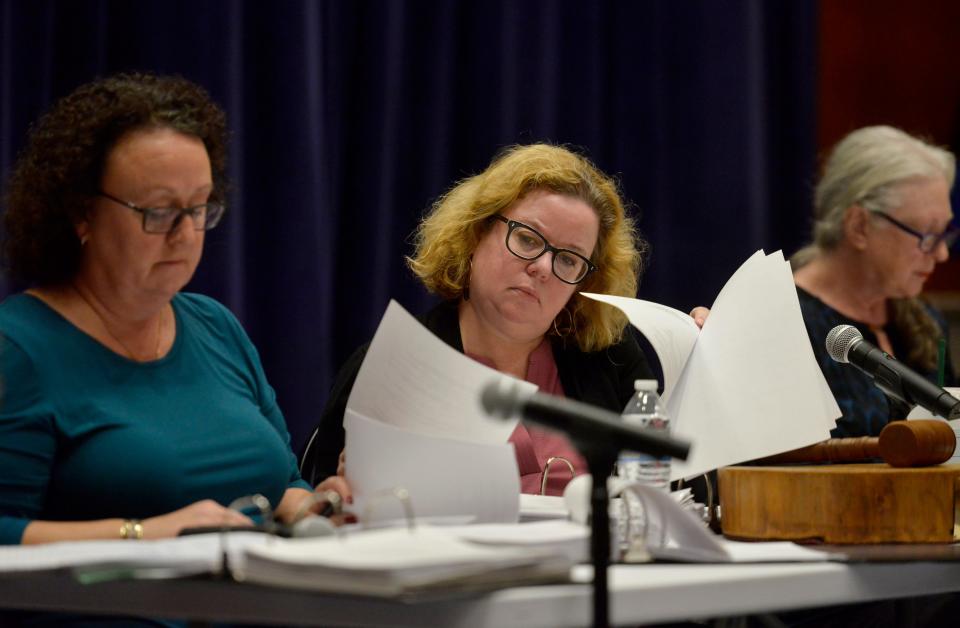 Truro Town Clerk Elisabeth Verde, center, looks through paperwork on the hearing of voter Susan Rocca with Board of Registrars members Julie Cataldo, left, and Elizabeth Sturdy. Rocca's was the first hearing on Monday at the Truro Community Center, and the board voted to allow her to remain a Truro voter. Truro voter Raphael Richter filed 66 challenges related to voter residency in the town of Truro. To see more photos, go to www.capecodtimes.com.