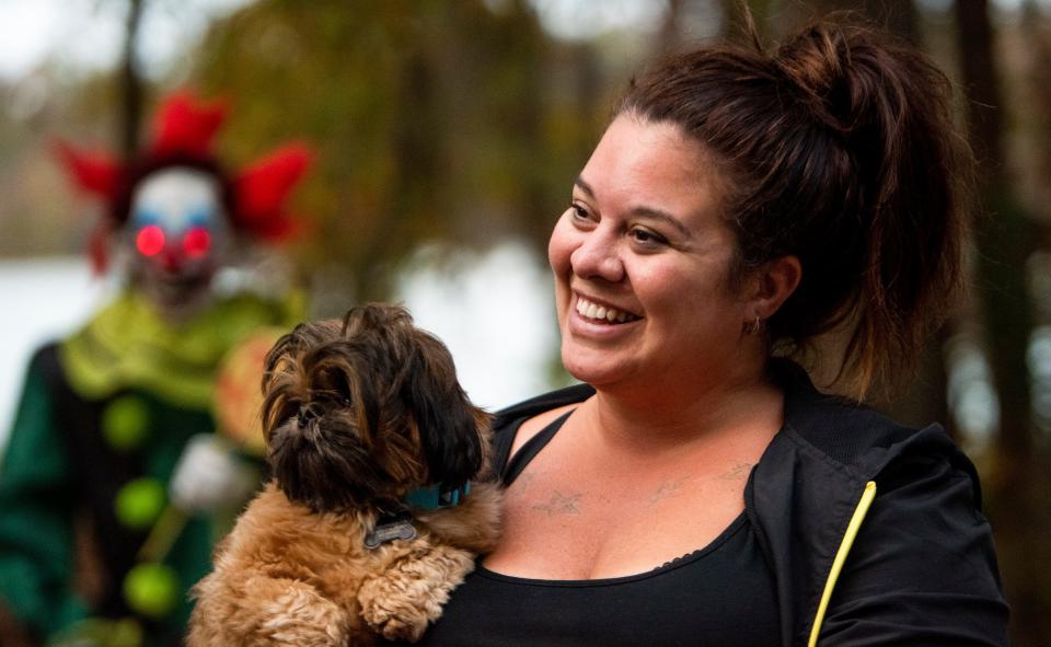 Camper Kelli Ewing holds her dog Murphy as campers deck out their campsites with Halloween decorations at the Gunter Hill Campground in Montgomery, Ala., on Friday, Oct. 28, 2022.