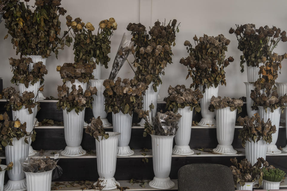 Dried flower bouquets inside a flower shop in a temporary closed market Kharkiv, eastern Ukraine, Tuesday, May 24, 2022. (AP Photo/Bernat Armangue)