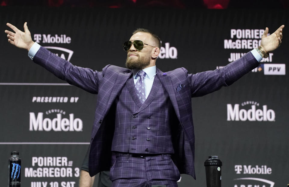 Conor McGregor motions to the crowd during a news conference for a UFC 264 mixed martial arts bout Thursday, July 8, 2021, in Las Vegas. McGregor is scheduled to fight Dustin Poirier in a lightweight bout Saturday in Las Vegas (AP Photo/John Locher)