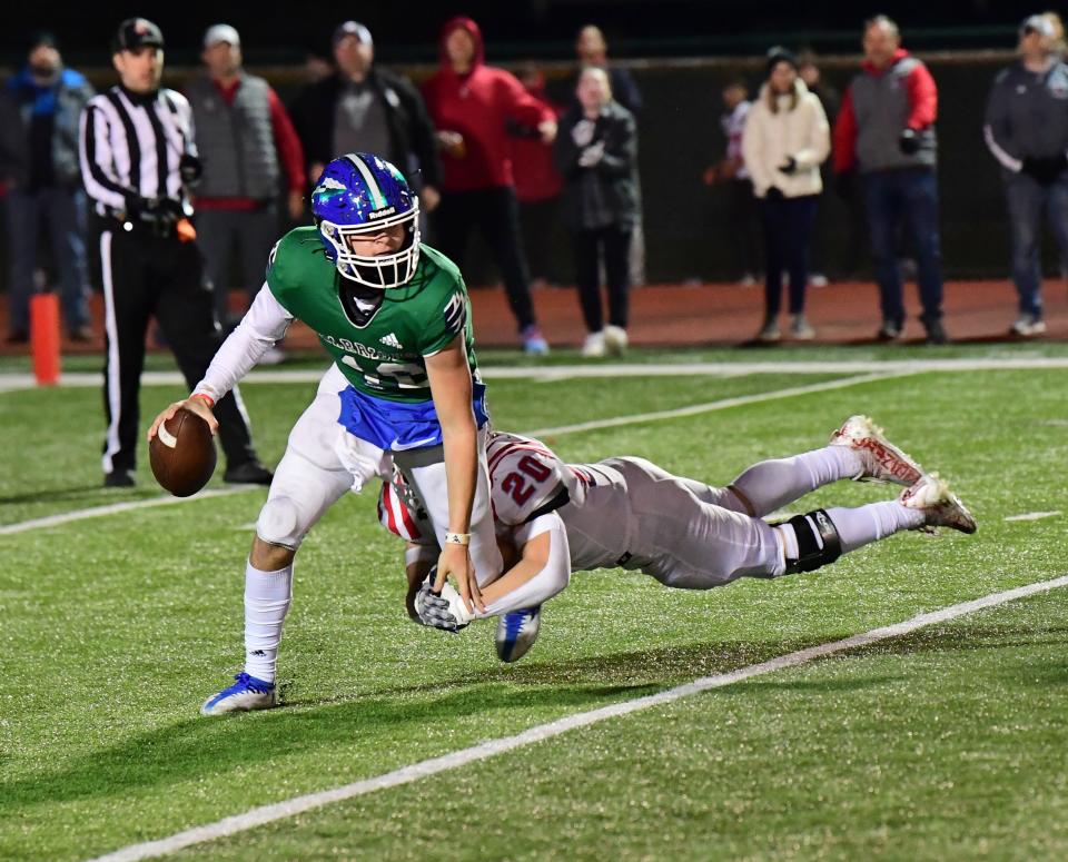 Hunter Jones takes down Vance George (18) of Winton Woods for a sack for the Knights at the OHSAA Division II region semifinal football game, Nov. 11.