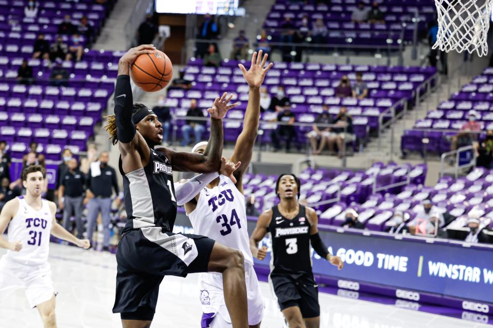 Providence's Greg Gantt goes strong to the hoop against TCU's Kevin Easley Jr. during a game in 2021.