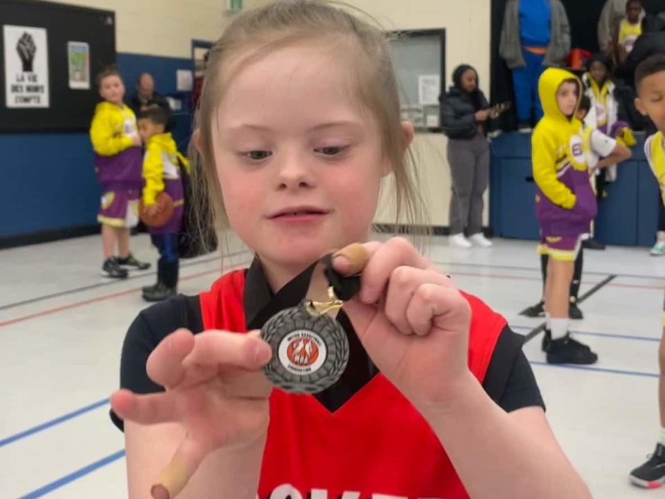 Charley Bond-Hill is shown with a medal she won this season playing for the Cole Harbour Rockets basketball team. (Submitted by Ben Hill - image credit)