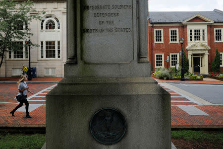 A pedestrian walks past a monument to Confederate Civil War soldiers, ahead the one-year anniversary of the fatal white-nationalist rally, in Charlottesville, Virginia, U.S., August 1, 2018. REUTERS/Brian Snyder