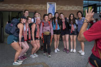 American tourists take a photo with Norwegian climber Kristin Harila, 37, center, as she arrives in Kathmandu, Nepal, Tuesday, June 6, 2023. The Norwegian who is aiming to be the fastest climber to scale all the world's 14 highest mountains announced she is shortening her goal and do it in half the time than initial target. (AP Photo/Niranjan Shrestha)