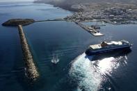 A ferry approaches the port on the Aegean island of Naxos, Greece, Friday, May 14, 2021. Greece launched its tourism season Friday amid a competitive scramble across the Mediterranean to lure vacationers emerging from lockdowns. (AP Photo/Thanassis Stavrakis)