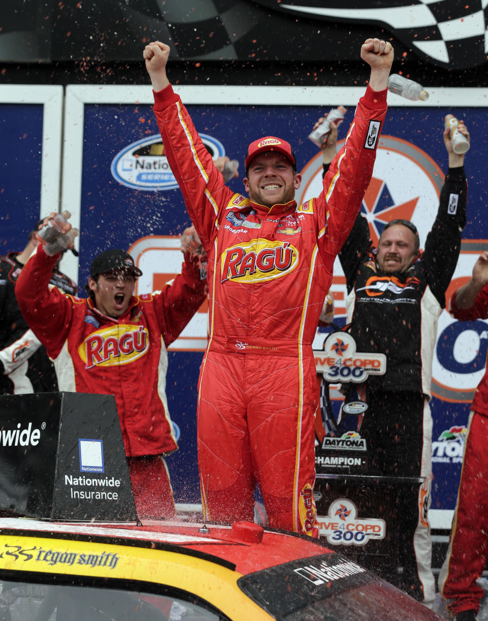 Regan Smith celebrates in the Victory Lane after winning the NASCAR Nationwide series auto race at Daytona International Speedway in Daytona Beach, Fla., Saturday, Feb. 22, 2014. (AP Photo/Chuck Burton)