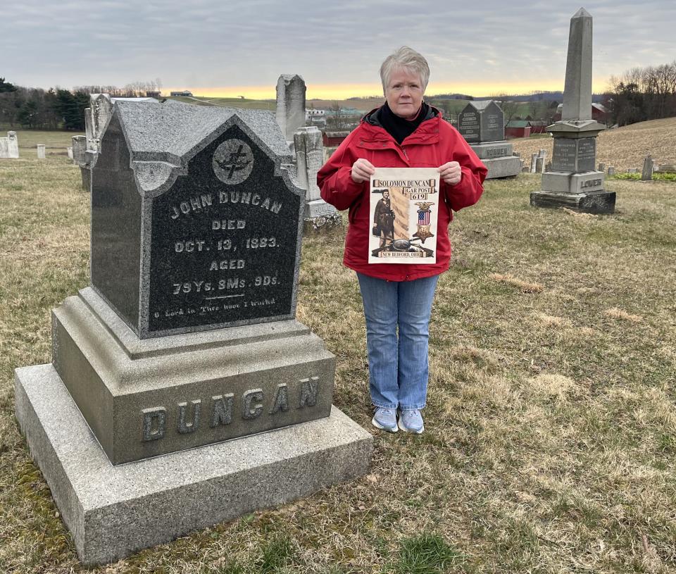 Linda Stefanov, commander of American Legion Post No. 494 in Sugarcreek, holds a flag that will fly at the grave marker of Civil War soldier Solomon Duncan at Zion Cemetery in New Bedford.