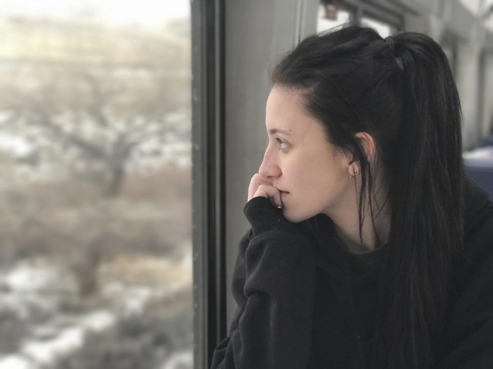 In this photo taken Wednesday, Jan. 25, 2017, Sabrina Feldman, 19, looks out the window and thinks about her future in California. AP Tampa correspondent Tamara Lush spent 15 days traveling via train across the U.S. as part of Amtrak's residency program, designed for creative professionals to spend time writing on the rails. She spoke with dozens of people _ fellow travelers, friends and family waiting for loved one at stations, train workers _ and filed occasional dispatches for the Tales on a Train project. (AP Photo/Tamara Lush)