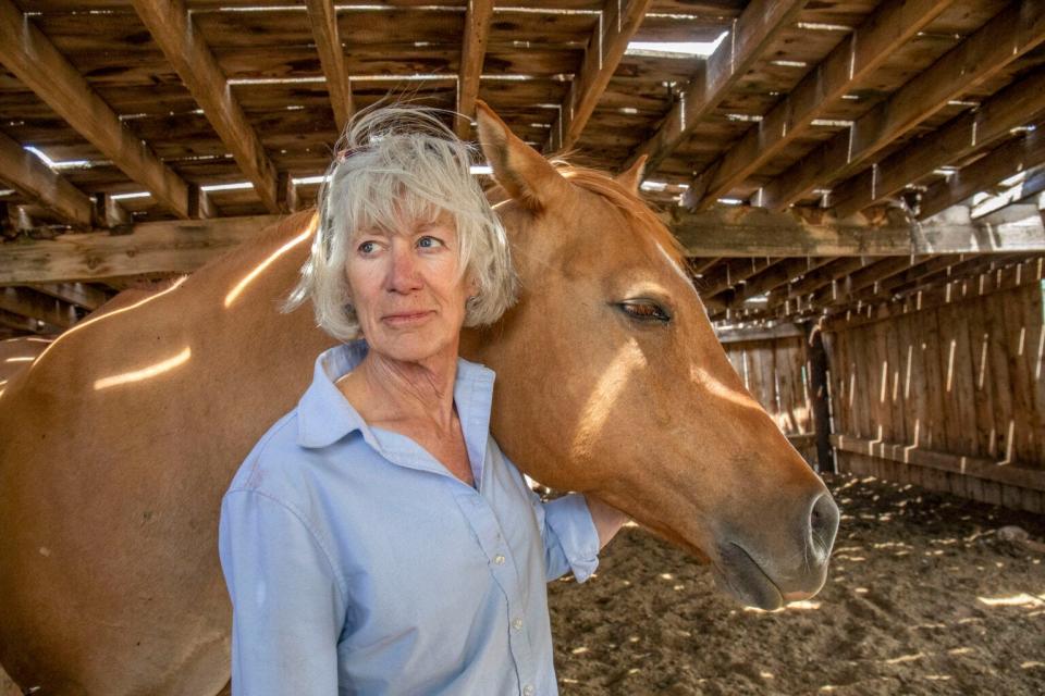 Linda Schoonover cradles one of her geldings on her ranch outside of Monte Vista. “If you ever look in a cow’s eye, or a horse’s eye, you see a wisdom there that they know something you don’t know,” she said.