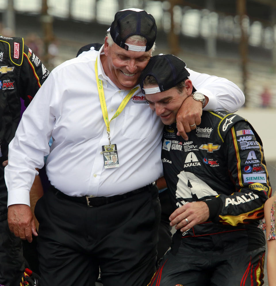 FILE - Jeff Gordon, right, celebrates with his team owner Rick Hendrick after winning the NASCAR Brickyard 400 auto race at Indianapolis Motor Speedway in Indianapolis, Sunday, July 27, 2014. Rick Hendrick and Hendrick Motorsports are marking the 40th anniversary of NASCAR’s winningest team.(AP Photo/R Brent Smith, File)