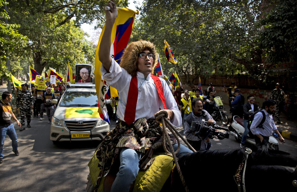 A horse mounted exile Tibetan shouts slogans during a march to mark the 60th anniversary of the March 10, 1959 Tibetan Uprising Day, in New Delhi, India, Sunday, March 10, 2019. The uprising of the Tibetan people against the Chinese rule was brutally quelled by Chinese army forcing the spiritual leader the Dalai Lama and thousands of Tibetans to come into exile. Every year exile Tibetans mark this day as the National Uprising Day. (AP Photo/Manish Swarup)