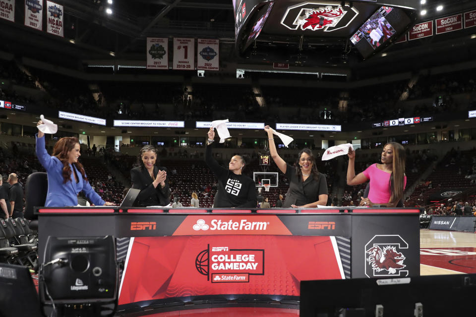 South Carolina head coach Dawn Staley, center, joins the set of ESPN College GameDay before an NCAA college basketball game against Georgia Sunday, Feb. 18, 2024, in Columbia, S.C. (AP Photo/Artie Walker Jr.)