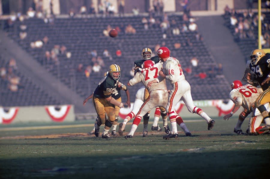 American football player Len Dawson (center, #16 in white), quarterback for the Kansas City Chiefs, throws the ball as opponant Lee Roy Coffey (left, #80) closes in during the first AFL-NFL World Championships (also known as Super Bowl I), Los Angeles, California, January 15, 1967. The Packers went on to win the game 35-10. (Photo by Robert Riger/Getty Images)