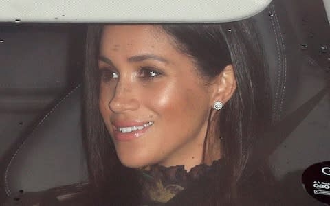 The Duchess of Sussex smiles as she arrives for the Christmas lunch hosted by the Queen - Credit: Max Mumby
