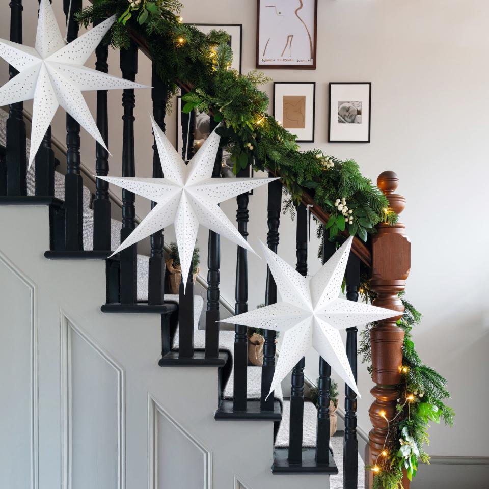 staircase with white Christmas stars and garland