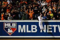 Nate McLouth #9 of the Baltimore Orioles climbs the wall as he can't make a play on a solo home run ball hit by Russell Martin #55 of the New York Yankees in the top of the ninth inning during Game One of the American League Division Series at Oriole Park at Camden Yards on October 7, 2012 in Baltimore, Maryland. (Photo by Patrick McDermott/Getty Images)