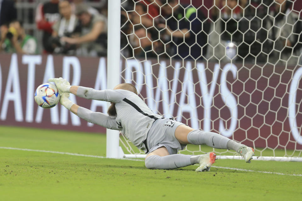 Australia's goalkeeper Andrew Redmayne saves during a penalty shoot out during the World Cup 2022 qualifying play-off soccer match between Australia and Peru in Al Rayyan, Qatar, Monday, June 13, 2022. (AP Photo/Hussein Sayed)