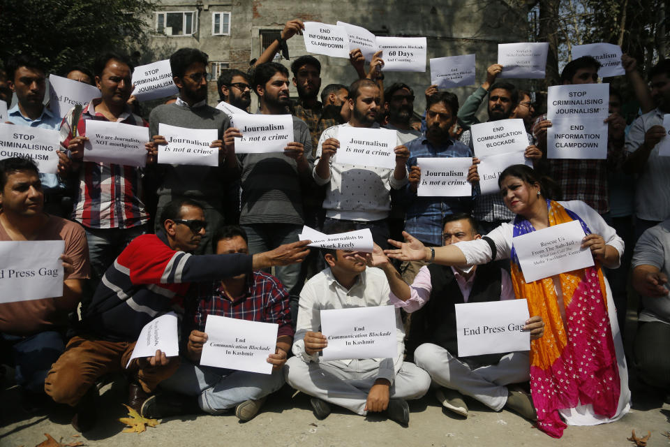 Kashmiri journalists display placards during a protest against the communication blackout in Srinagar, Indian controlled Kashmir, Thursday, Oct. 3, 2019. For the last two months, mobile phones and internet services have been shut down in the valley after New Delhi stripped Indian-controlled Kashmir of its semi-autonomous powers and implemented a strict clampdown, snapping communications networks, landlines and mobile Internet. (AP Photo/Mukhtar Khan)