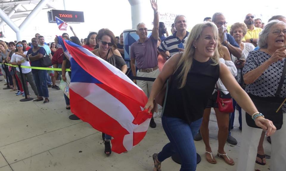 Families of Caribbean hurricane evacuees who arrived at Port Everglades, Florida, on board the Royal Caribbean Adventure of the Seas, rush to greet their relatives.