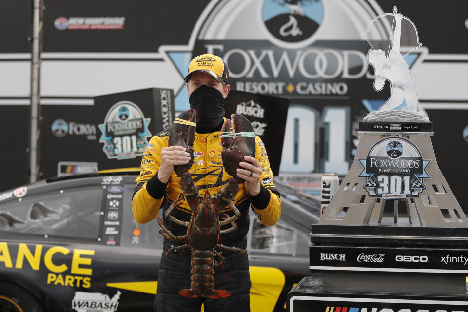 Brad Keselowski holds a giant lobster to celebrate his victory in Loudon, New Hampshire.