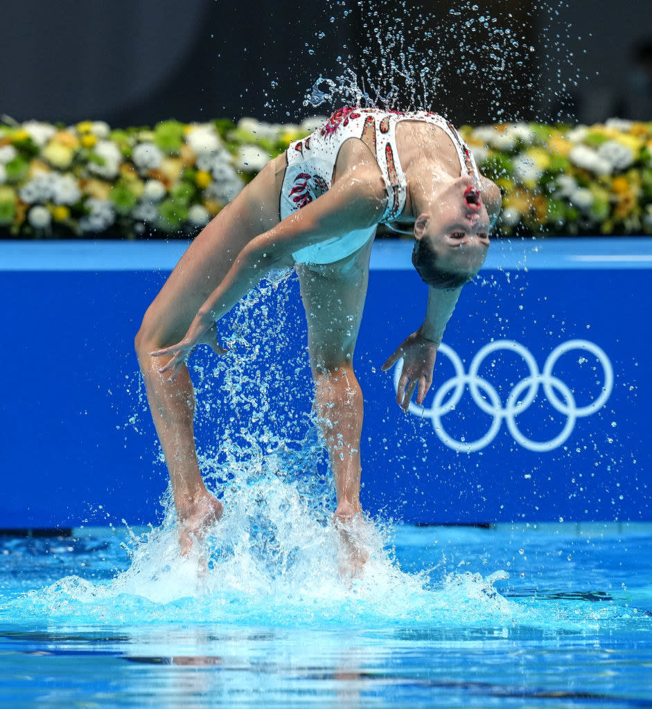 A swimmer doing a backflip out of the water