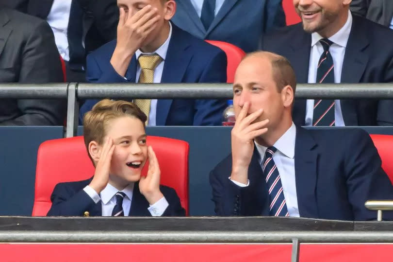 Prince George and Prince William share a light moment during the FA Cup Final at Wembley 2024