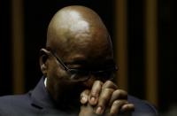 Former South African President Jacob Zuma sits in court where he is facing charges that include fraudâ corruption and racketeering in Pietermaritzburg