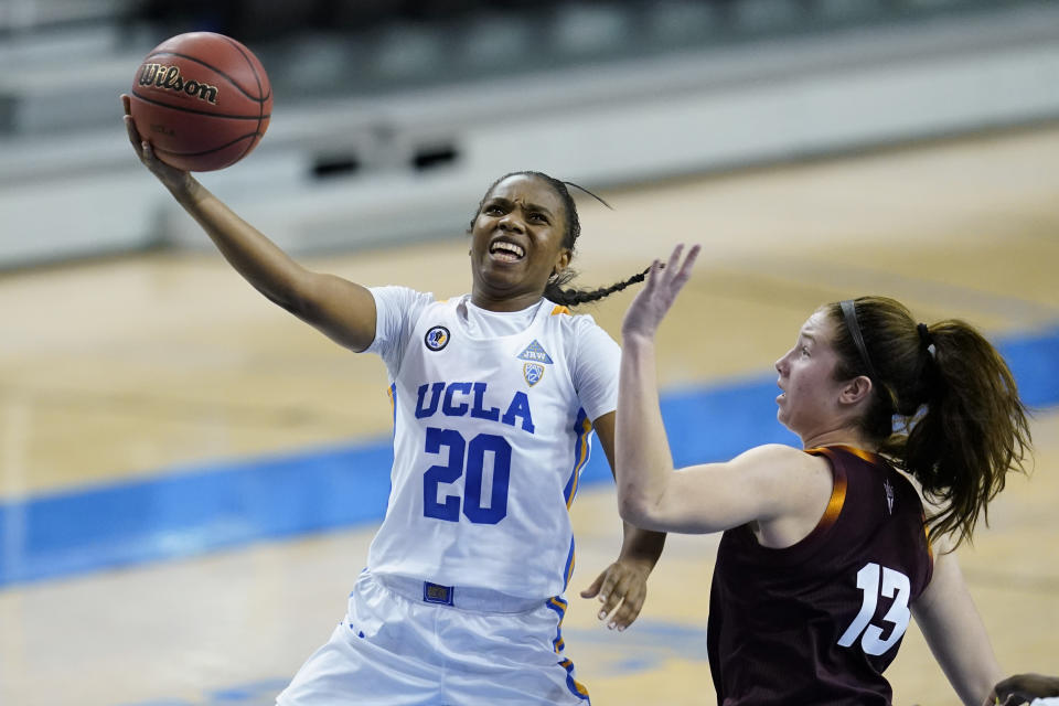 FILE - UCLA guard Charisma Osborne (20) shoots next to Arizona State guard Maggie Besselink (13) during the third quarter of an NCAA college basketball game in Los Angeles, in this Friday, Jan. 29, 2021, file photo. No. 4 Stanford remains the class of the conference as it enters a Pac-12 women’s tournament loaded with strong teams at the top, including No. 9 UCLA and No. 11 Arizona. (AP Photo/Ashley Landis, File)