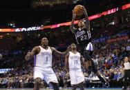 Sacramento Kings guard Isaiah Thomas (22) shoots in front of Oklahoma City Thunder center Kendrick Perkins (5) and guard Reggie Jackson (15) in the first quarter of an NBA basketball game in Oklahoma City, Sunday, Jan. 19, 2014. (AP Photo/Sue Ogrocki)