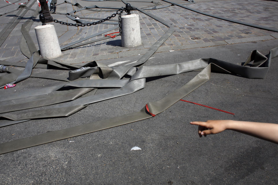 Fire hoses lay on the floor near Notre Dame cathedral, in Paris, Friday, April 19, 2019. Rebuilding Notre Dame, the 800-year-old Paris cathedral devastated by fire this week, will cost billions of dollars as architects, historians and artisans work to preserve the medieval landmark. (AP Photo/Thibault Camus)