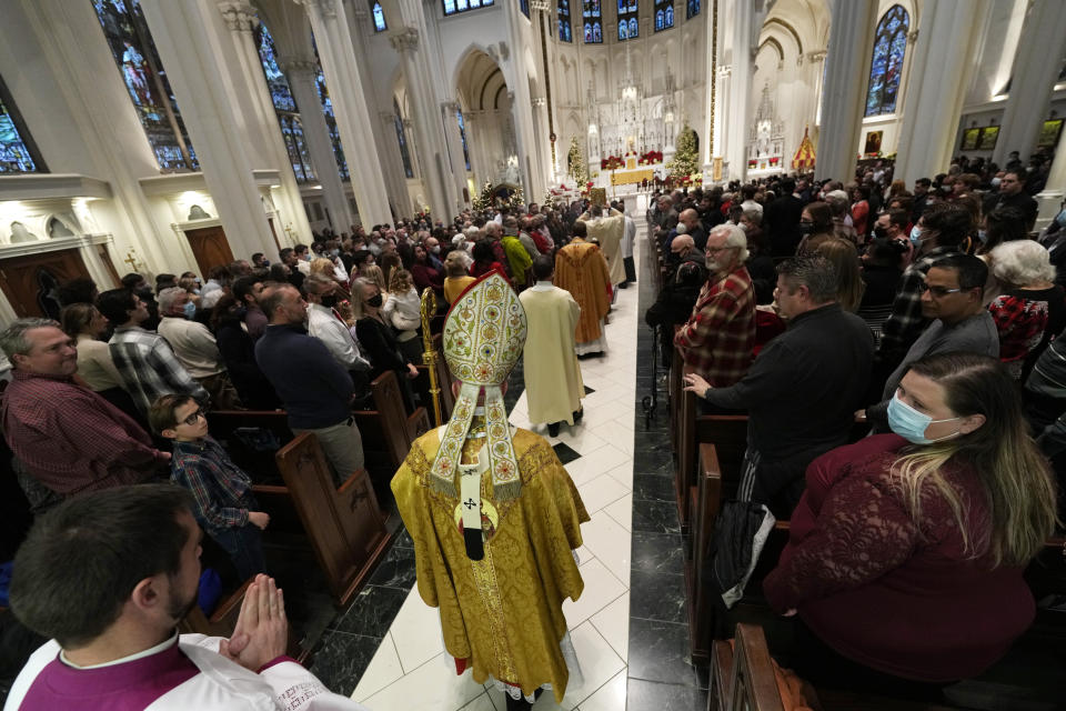 Most Rev. Samuel J. Aquila, archbishop of the archdiocese of Denver, heads down the aisle to conduct Christmas Eve Mass in the Cathedral Basilica of the Immaculate Conception, Friday, Dec. 24, 2021, in downtown Denver. (AP Photo/David Zalubowski)