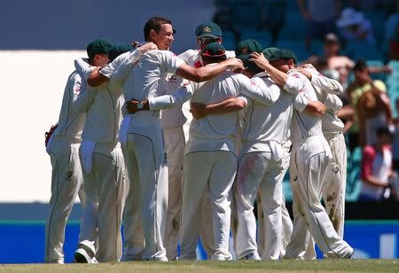 Cricket - Australia v Pakistan - Third Test cricket match - Sydney Cricket Ground, Sydney, Australia - 7/1/17 Australia's Josh Hazlewood celebrates with team mates after taking the final wicket of Pakistan's Imran Khan to win the match. REUTERS/David Gray/Files