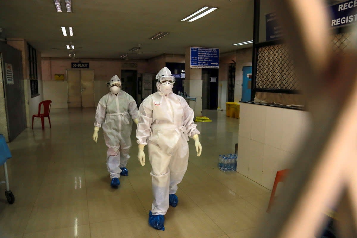 File. Health officials in full protective gear walk inside an isolation ward in October 2021 in the Indian state of Kerala after 23-year-old was infected by the potentially deadly Nipah virus (AFP via Getty Images)