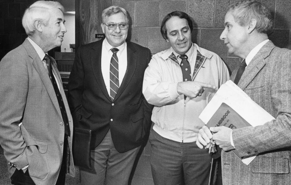 Reid Ross principal Jack McGinley, right, and athletic director John Daskal, second from right, talk with NCHSAA executive director Charlie Adams, left as Cumberland County employee Earl Butler provides directions to courtroom, March 1, 1985.