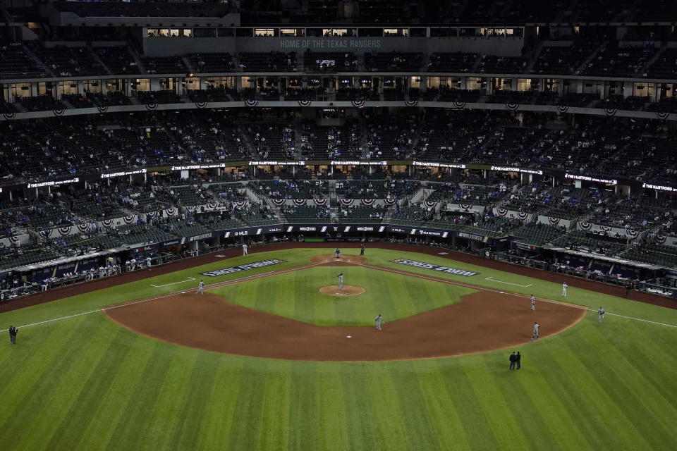 FILE - The Los Angeles Dodgers and Tampa Bay Rays play during the sixth inning in Game 6 of the baseball World Series at Globe Life Field, Oct. 27, 2020, in Arlington, Texas. Game 6 ended the neutral-site playoffs MLB held in 2020 at the stadium, where this year's postseason games are back and the home team Texas Rangers are playing in them there for the first time. (AP Photo/Sue Ogrocki, File)