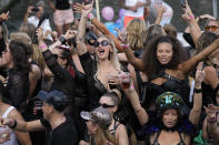 People dance on a boat as hundreds of thousands of people lined canals in the Dutch capital to watch the colorful spectacle of the Pride Canal Parade return for the 25th edition after the last two events were canceled due to the COVID-19 pandemic, in Amsterdam, Netherlands, Saturday, Aug. 6, 2022. (AP Photo/Peter Dejong)