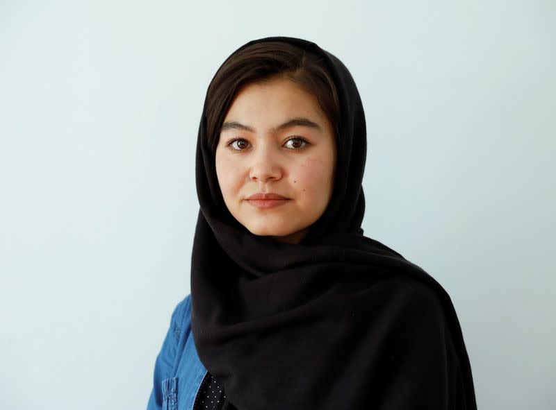 Shamsia Alizada,18, who has come top in the country's university entrance exam, speaks during an interview at her house in Kabul