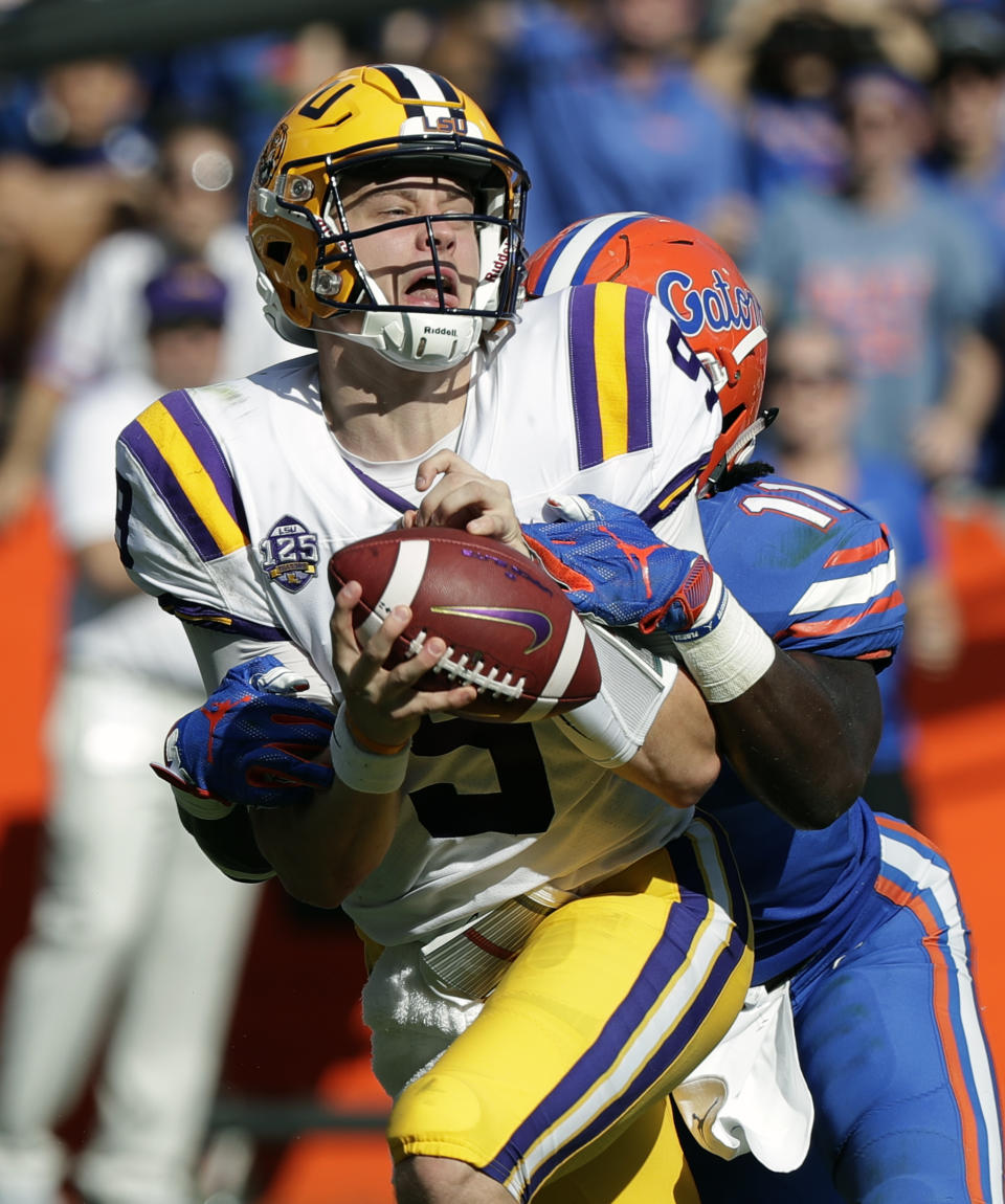 LSU quarterback Joe Burrow, left, is sacked by Florida linebacker Vosean Joseph during the first half of an NCAA college football game, Saturday, Oct. 6, 2018, in Gainesville, Fla. (AP Photo/John Raoux)