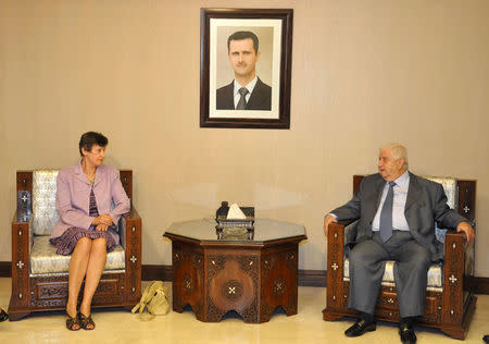 FILE PHOTO: Syrian Foreign Minister Walid al-Muallem (R) meets U.N. High Representative for Disarmament Affairs Angela Kane in Damascus, Syria in this handout photo distributed by Syria's national news agency SANA on August 25, 2013. SANA/Handout via REUTERS/File Photo