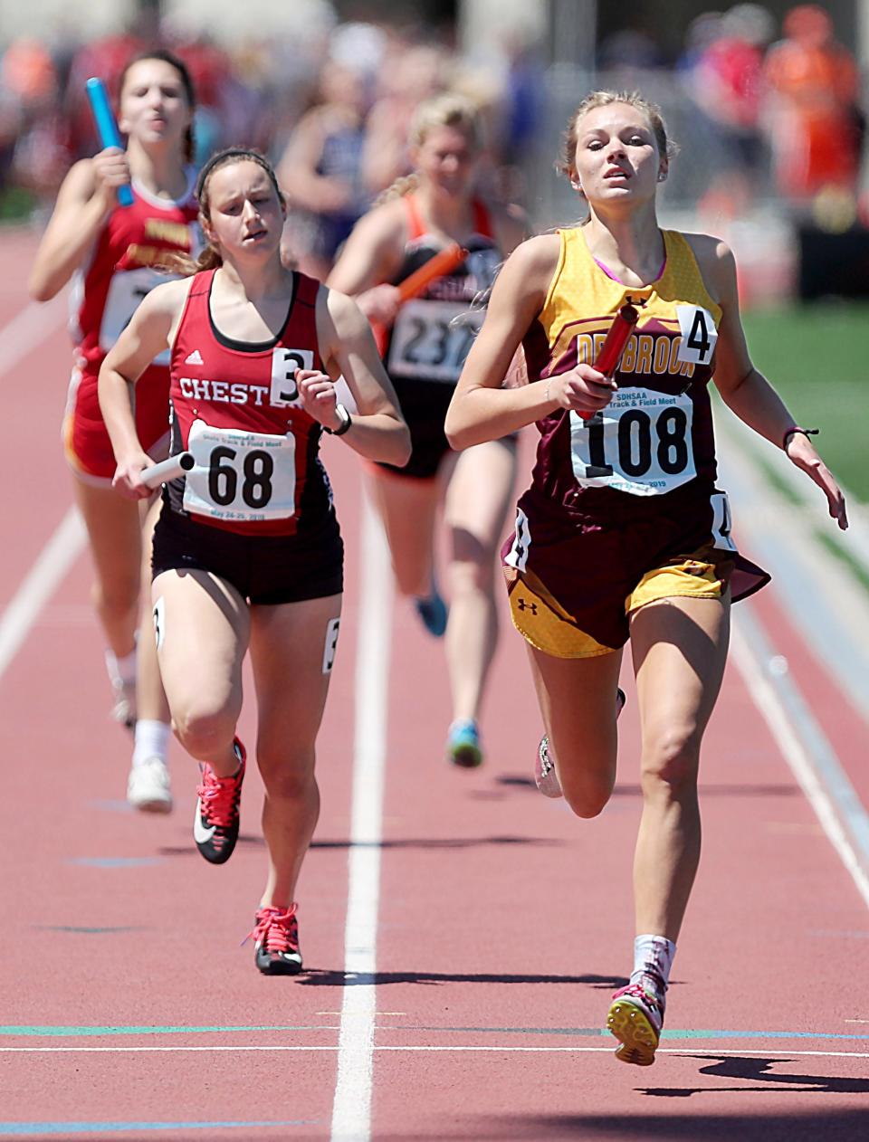 Deubrook Area’s Shaylee DeBeer, right, leads Chester Area’s Makenna Larson, left, to the finish line as they anchor the Class B girls 1,6000-meter relay in the 2019 South Dakota State Track and Field Meet at Howard Wood Field in Sioux Falls. The Dolphins won the event and nailed down their third consecutive state Class B girls championship.