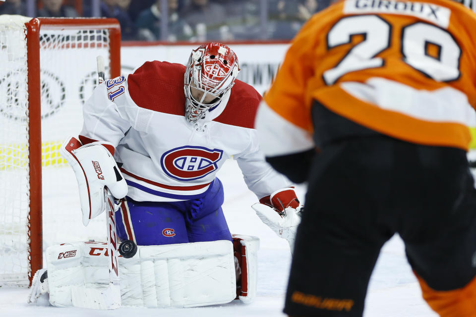 Montreal Canadiens' Carey Price, left, blocks a shot past Philadelphia Flyers' Claude Giroux during the second period of an NHL hockey game, Thursday, Jan. 16, 2020, in Philadelphia. (AP Photo/Matt Slocum)