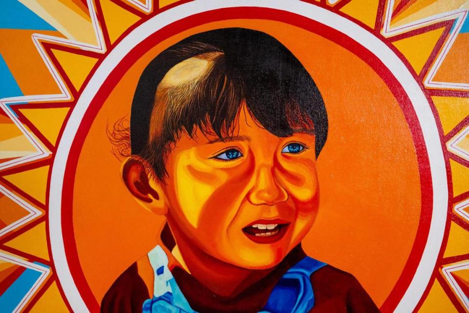 Cesar Velez’s work “Libre” was painted from a boyhood photo of the artist. Velez says the image shows him stepping out of the shadows into the light, which he equates to coming out about his undocumented immigration status. Emily Curiel/ecuriel@kcstar.com