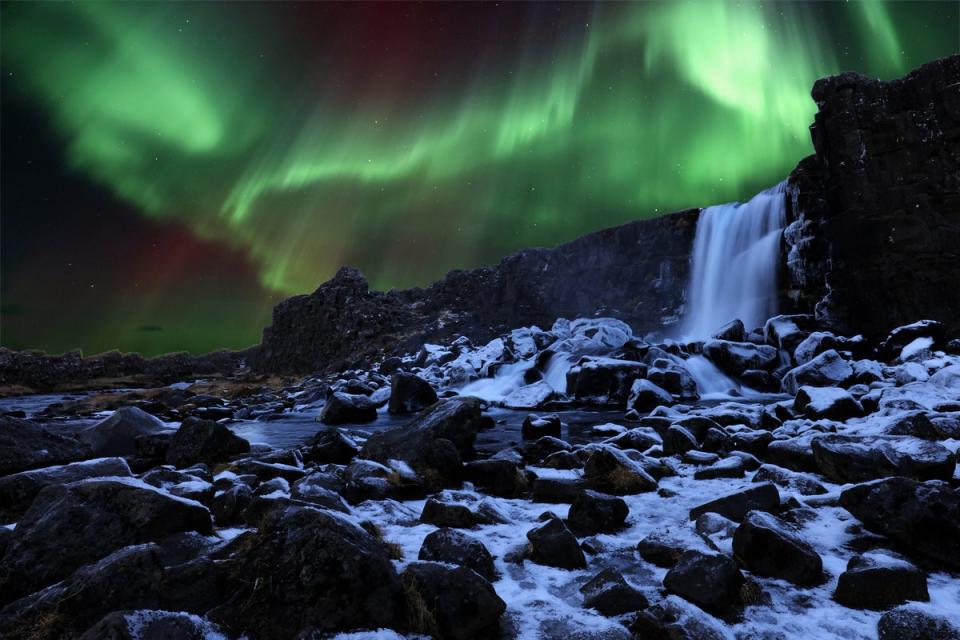 The Aurora Borealis lights up the sky above a waterfall in Thingvellir National Park (Getty Images/iStockphoto)