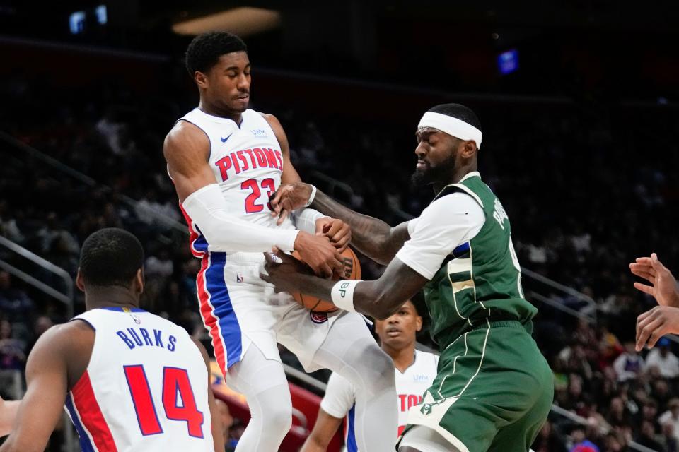Detroit Pistons guard Jaden Ivey (23) and Milwaukee Bucks forward Bobby Portis (9) battle for the ball in the first half of an NBA basketball game in Detroit, Monday, Jan. 22, 2024. (AP Photo/Paul Sancya)