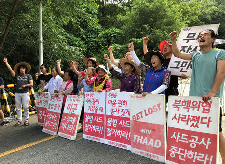 Villagers holding banners bearing their demands chant slogans during an anti-THAAD protest near an entrance of a golf course where a Terminal High Altitude Area Defense (THAAD) system is deployed, in Seongju, South Korea, July 4, 2018. Picture taken July 4, 2018. REUTERS/Kim Jeong-min