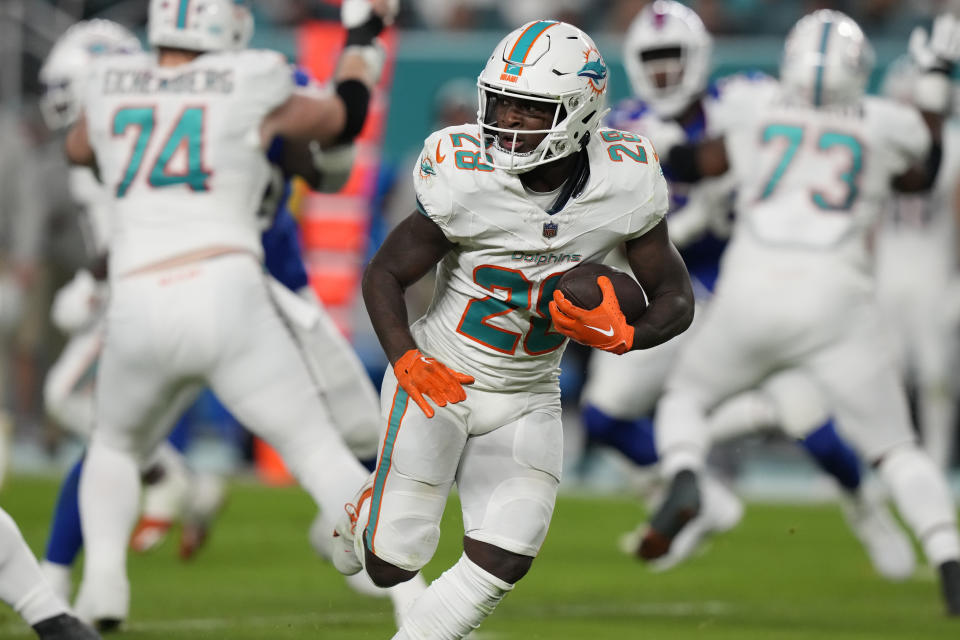 Miami Dolphins running back De'Von Achane (28) runs with the football during the first half of an NFL football game against the Buffalo Bills, Sunday, Jan. 7, 2024, in Miami Gardens, Fla. (AP Photo/Lynne Sladky)