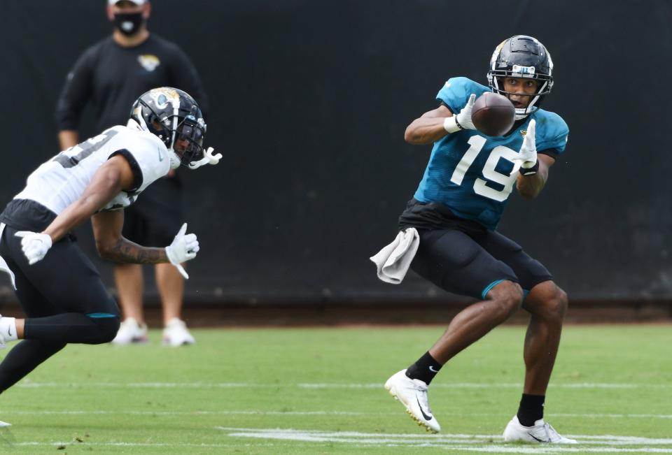 Jaguars WR, #19, Collin Johnson pulls in a pass during Saturday's practice session. The Jacksonville Jaguars held a practice session and scrimmage at TIAA Bank Field in Jacksonville, Florida Saturday, August 29, 2020. Selected guests and members of the media were invited to the soft opening of the stadium with new accommodations made to help reduce the chance of spreading the coronavirus. Seating capacity is limited and much of the available seating has been closed off to encourage social distancing. There is little opportunity for physical contact with doors, food purchasing and shopping inside the stadium with cashless and online purchasing.  [Bob Self/Florida Times-Union]